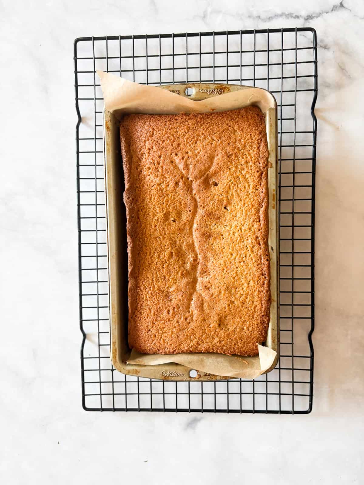 This rich and velvety gluten free lemon pound cake stays moist and tender for days! Made with oat and almond flour, cream cheese, and butter! A gluten free lemon pound cake cools in the pan.