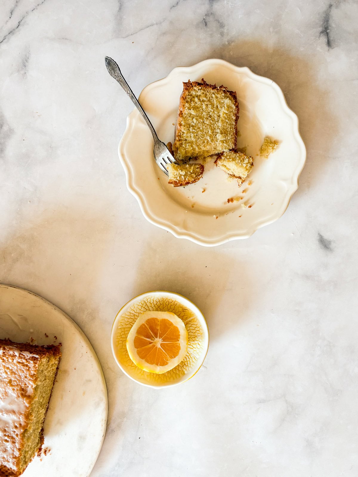 This easy homemade gluten free cake flour is perfect in cakes and more. Gluten-free flour and cornstarch feature in this DIY blend. A slice of gluten free lemon pound cake on a plate with a fork.