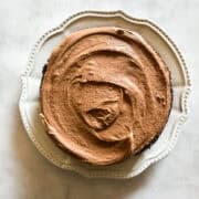 Chocolate frosting tops a vegan gluten free chocolate cake.