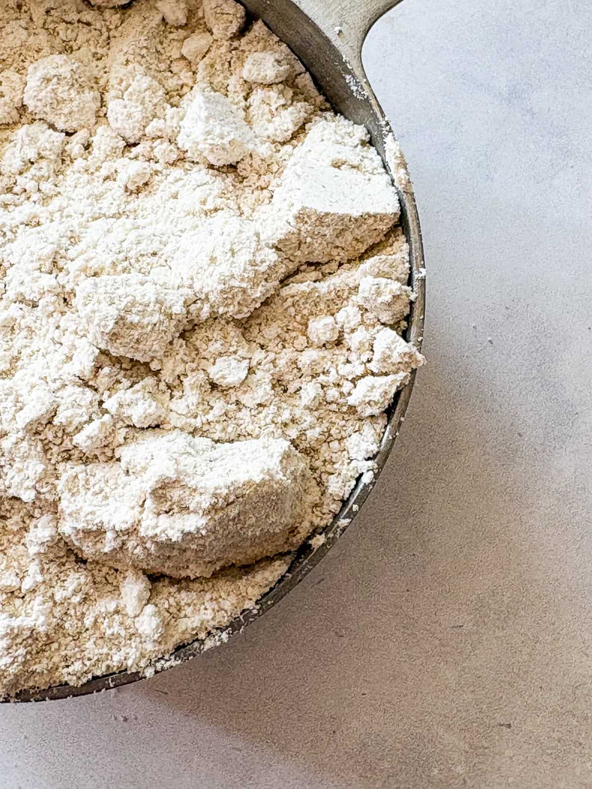 This easy homemade gluten free cake flour is perfect in cakes and more. Gluten-free flour and cornstarch feature in this DIY blend. A soft blend of gluten free cake flour in a close-up shot.