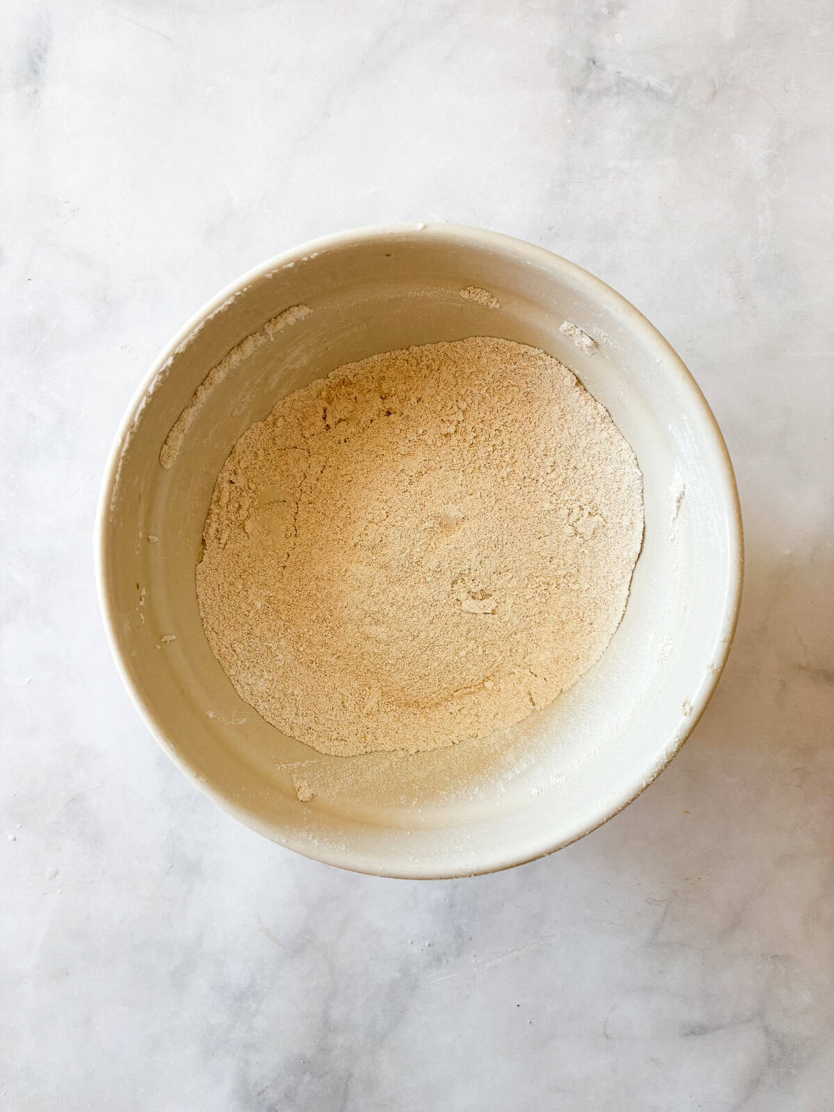 This easy homemade gluten free cake flour is perfect in cakes and more. Gluten-free flour and cornstarch feature in this DIY blend. Homemade cake flour in a bowl.