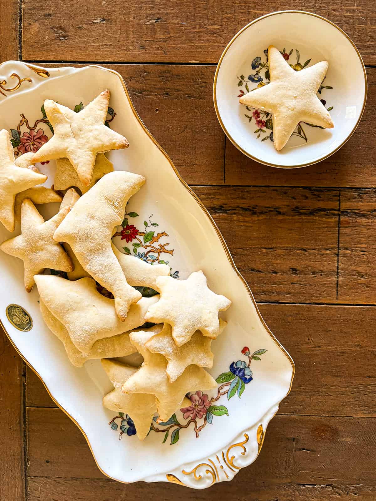 These kid-friendly, lower sugar sugar cookies feature all the buttery crispness of a classic sugar cookie, but with less sugar. GF option! A lower sugar sugar cookies star shaped cookie on a plate next to a platter of cookies.