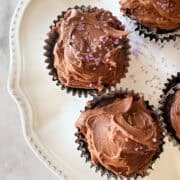 Icing sugar tops vegan gluten-free chocolate cupcakes.