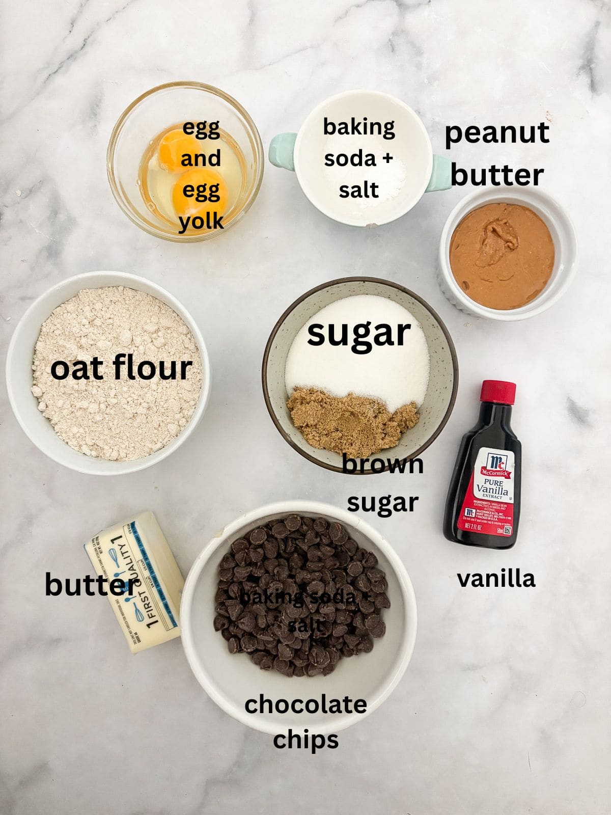 Chewy and irresistible, these gluten-free peanut butter chocolate chip cookies are made with plenty of creamy pb plus lots of chocolate! Ingredients for gluten-free peanut butter chocolate chip cookies are text-labeled.