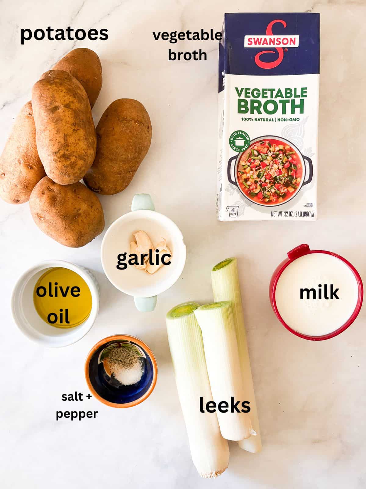 Rich and smooth vegetarian potato leek soup is made from simple ingredients that transform into something deliciously memorable. Ingredients for vegetarian potato leek soup are text-labeled.