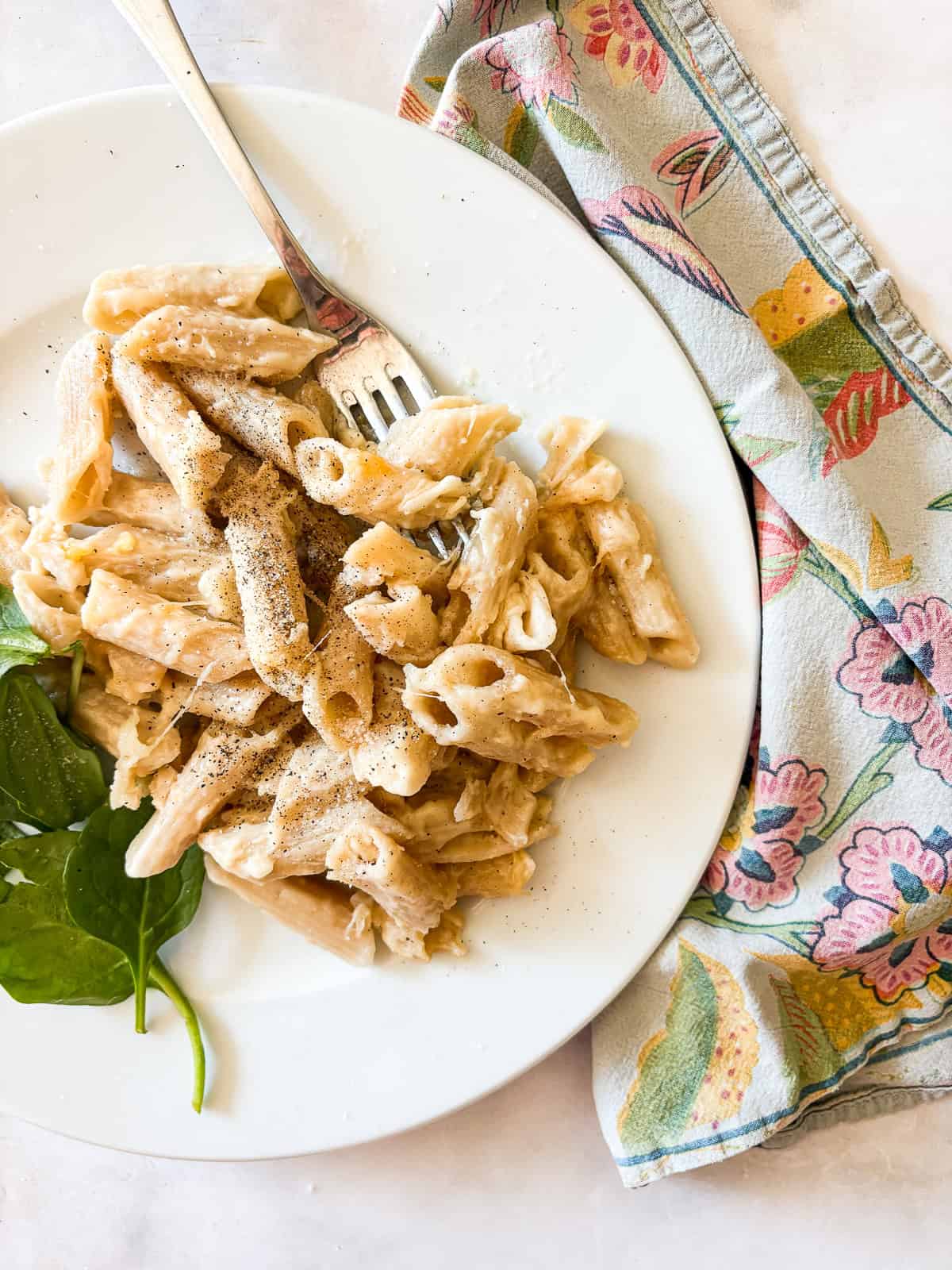 A fork rests on a plate of gluten free baked mac and cheese.