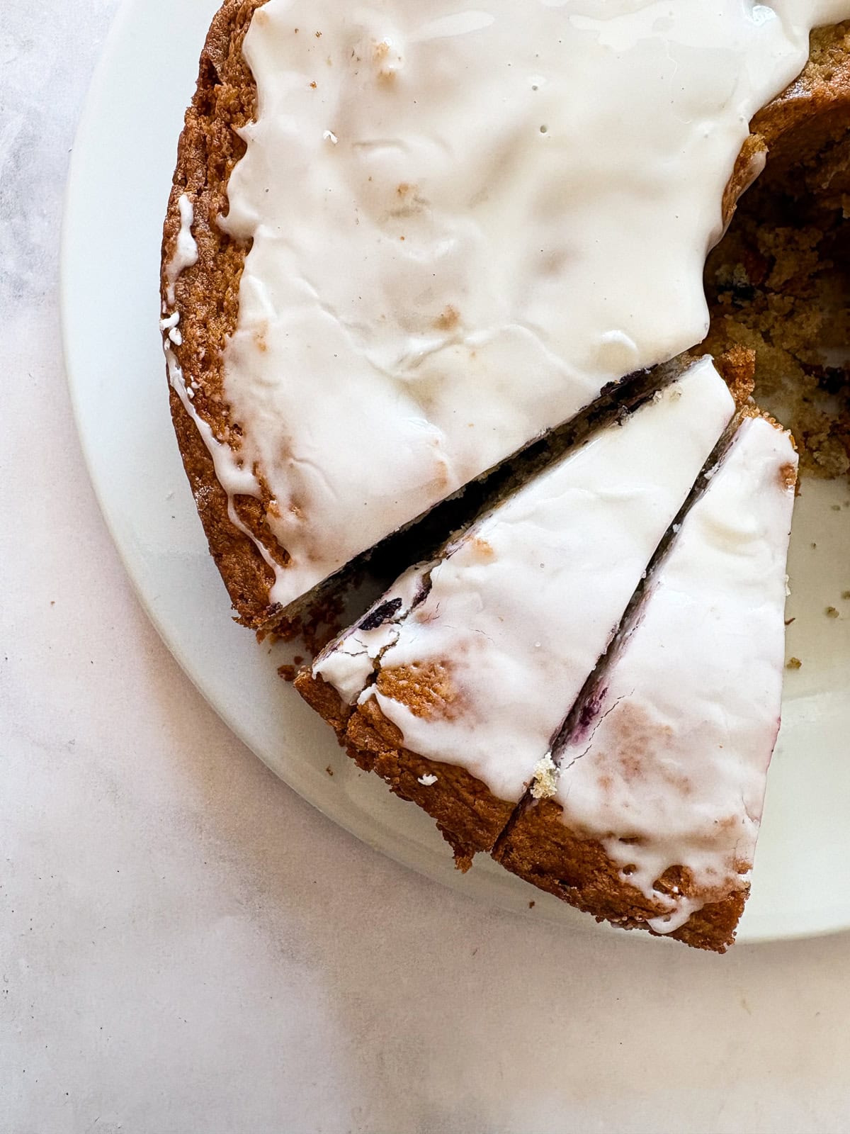 A rich and fluffy gluten free blueberry cake that's packed with loads of juicyberries - you'll taste them in every bite! Slices of a gluten free blueberry cake.