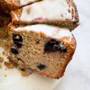 Slices of gluten free blueberry cake topped with lemon glaze.