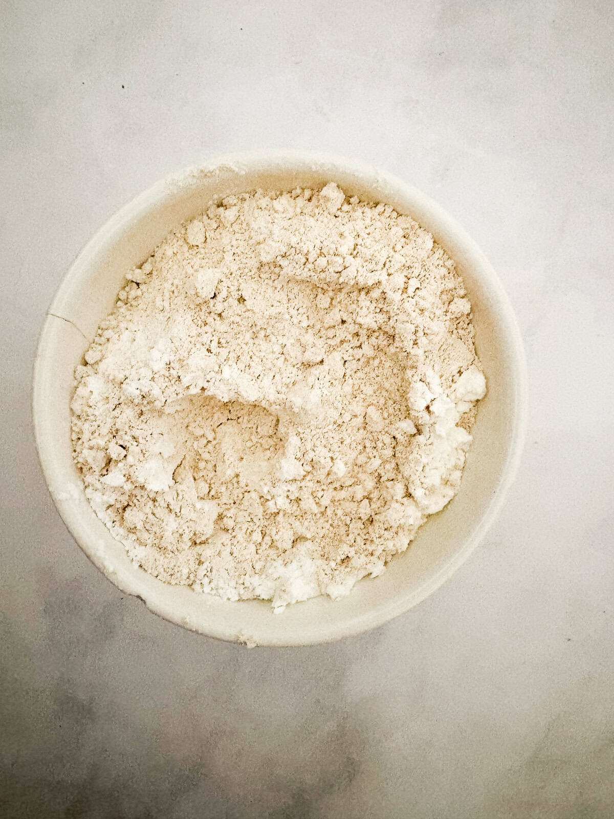 These soft and chewy gluten free lemon cookies are super flavorful thanks to bright lemon zest. Just one gluten-free flour is needed! Flour mix for gluten free lemon cookies in a bowl.