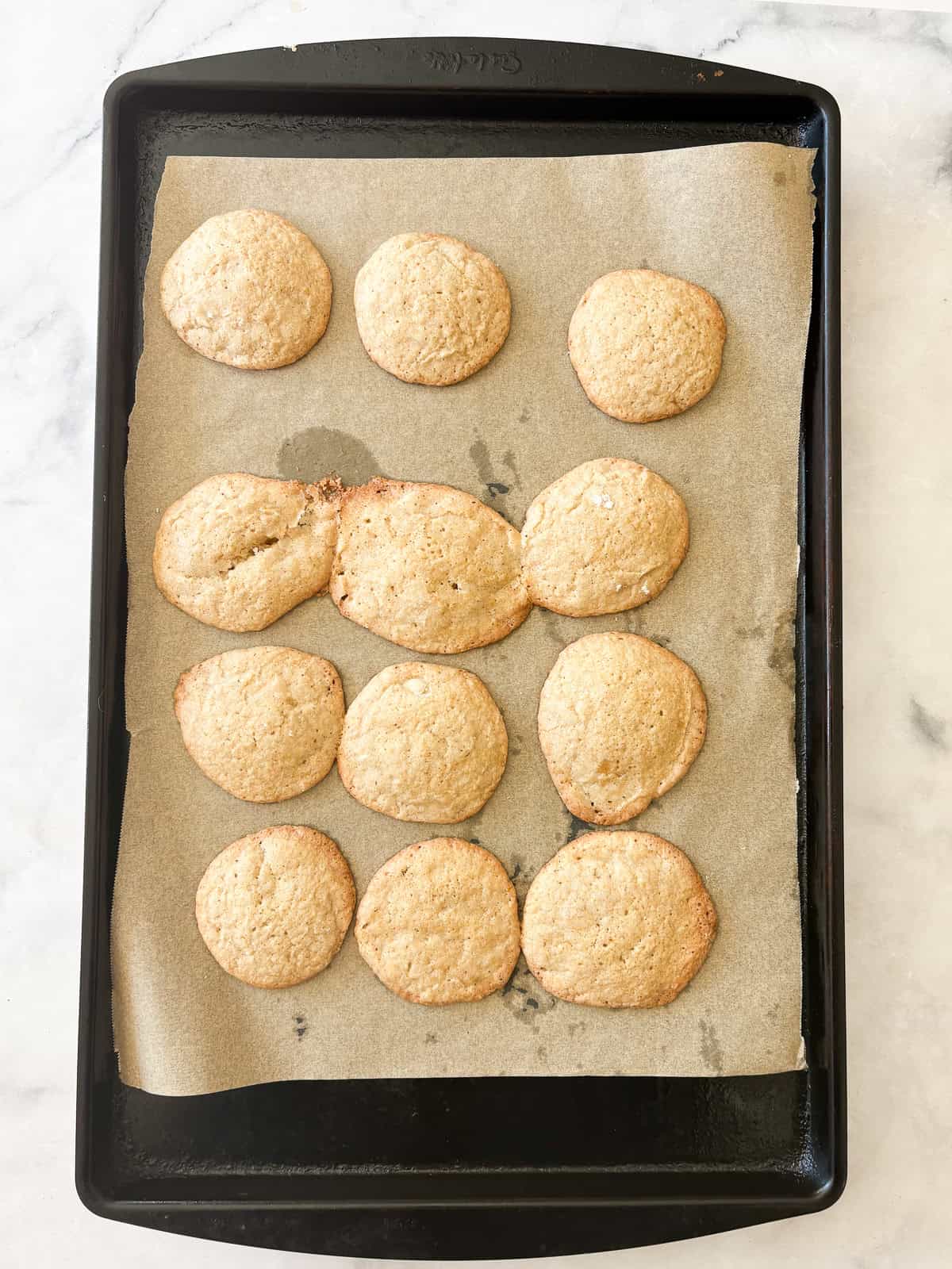 These soft and chewy gluten free lemon cookies are super flavorful thanks to bright lemon zest. Just one gluten-free flour is needed! Gluten free lemon cookies cool on a baking sheet.