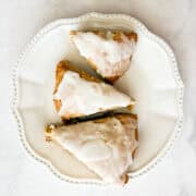 Three gluten free lemon scones on a plate.