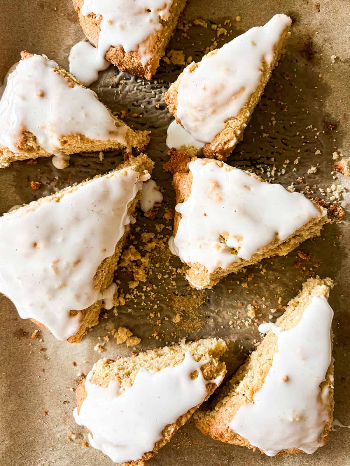 A bunch of gluten free lemon scones on a baking sheet.