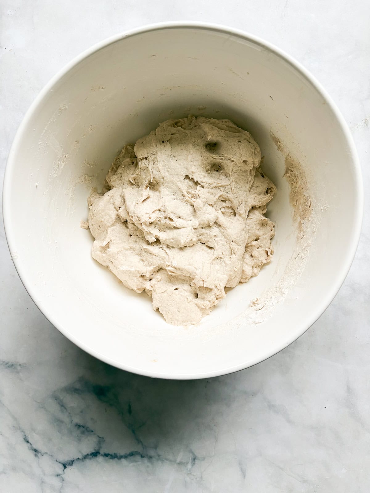 A crusty gluten-free no-knead bread recipe made with 4 simple ingredients. It bakes up perfectly every time and rivals any wheat-based bread! No knead gluten free bread dough after rising for 18 hours.