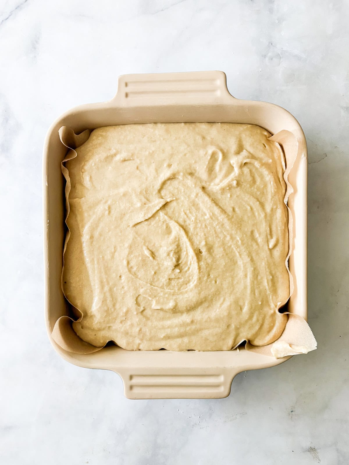 Whip up this one-bowl gluten free snack cake and enjoy with a cup of coffee, or have it waiting on the counter for when the kids come home. Batter for gluten free snack cake in a pan.