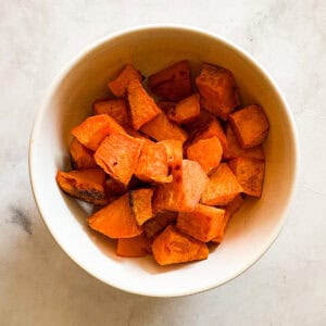 A bowl of baked sweet potato cubes.