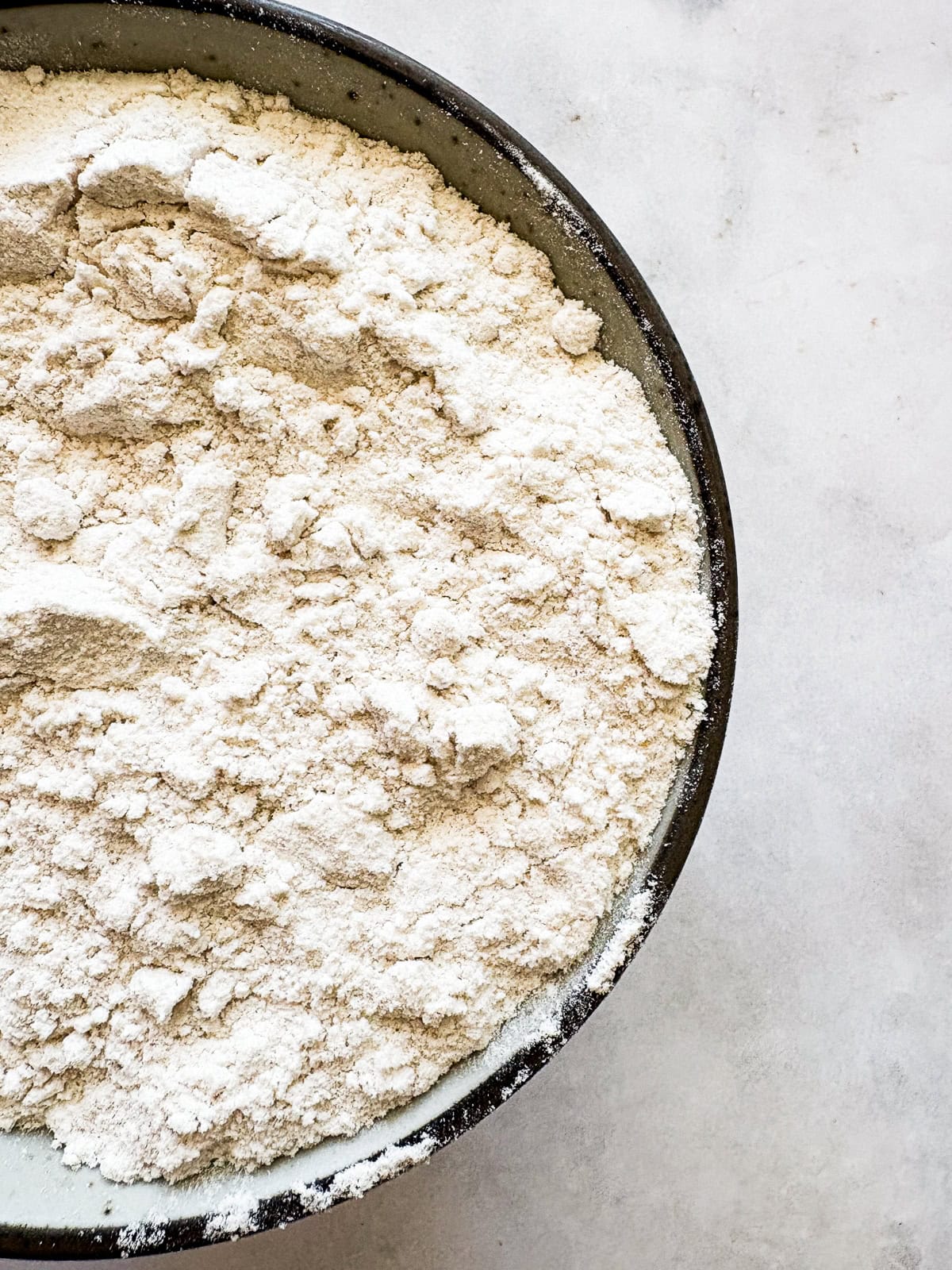 This gum-free, gluten free bread flour recipe is a go-to for breads and pastries of all kinds! Use it 1:1 in your favorite recipes. Close up of a bowl of homemade gluten free bread flour.