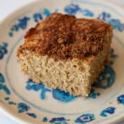 A fluffy piece of gluten free cinnamon and sugar cake on a plate.