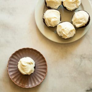 A plate of gluten free Guinness chocolate cupcakes with a cupcake on a separate plate.
