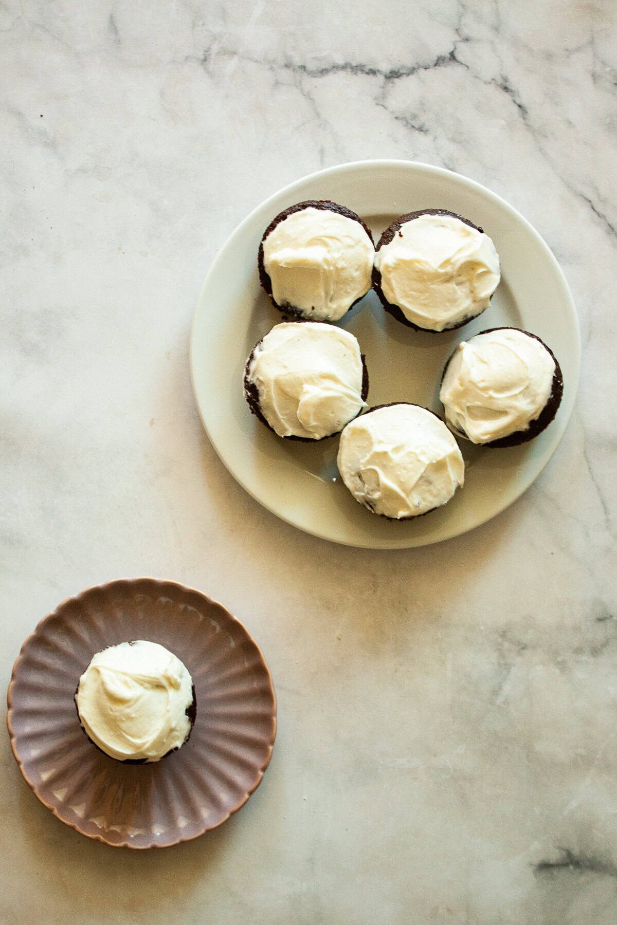 A plate of gluten free Guinness chocolate cupcakes with a cupcake on a separate plate.