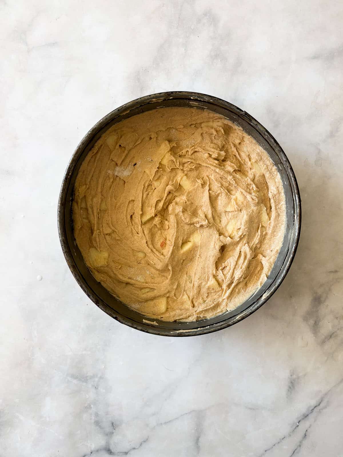 A soft and sweet gluten free Irish apple cake that's inspired by a traditional Irish recipe. Delicious plain, it can be served warm or cold. Batter for gluten free Irish apple cake in a cake pan.