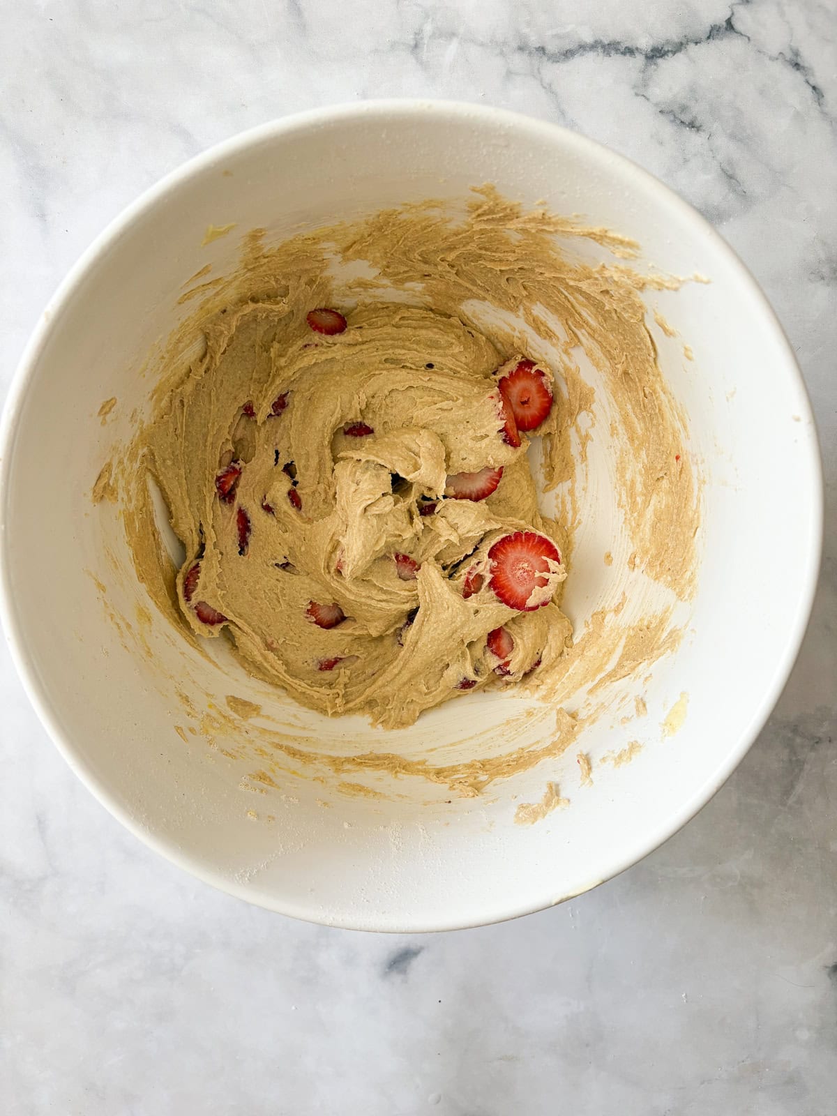 A gorgeous gluten free strawberry almond cake loaded with fresh fruit and topped with toasted almonds and a shower of powdered sugar. Sliced strawberries are added to cake batter.