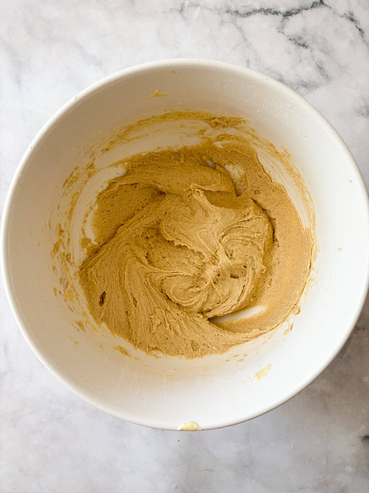 A gorgeous gluten free strawberry almond cake loaded with fresh fruit and topped with toasted almonds and a shower of powdered sugar. Adding flour to cake batter for strawberry almond cake.