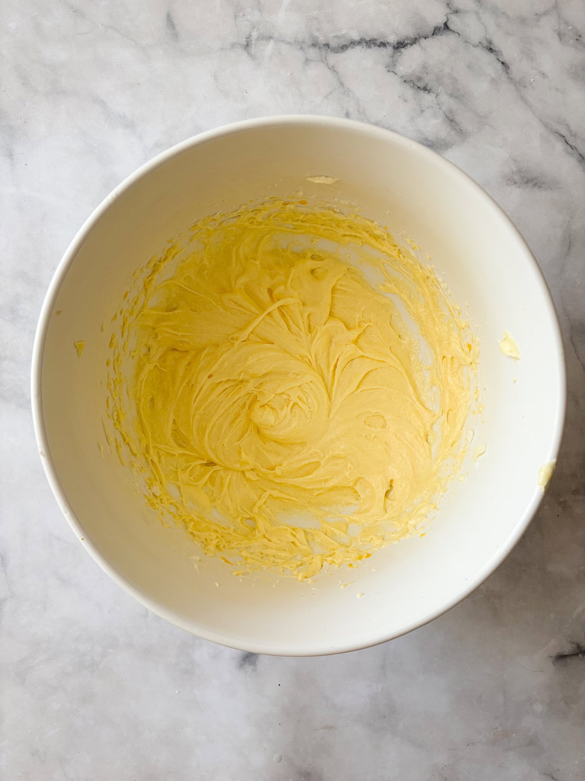 A gorgeous gluten free strawberry almond cake loaded with fresh fruit and topped with toasted almonds and a shower of powdered sugar. Creamed butter, oil, and sugar for strawberry almond cake.