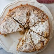 A gluten free strawberry almond cake in slices on a plate.