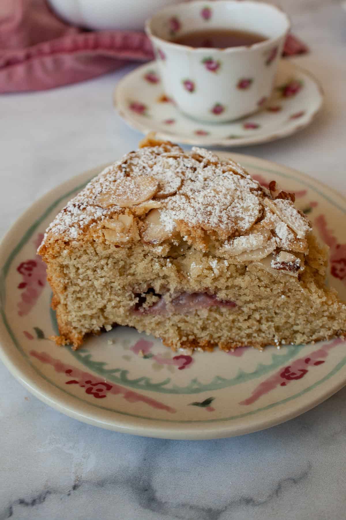 A slice of gluten free strawberry almond cake on a plate.