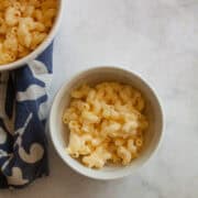 Two bowls of one pot gluten free mac and cheese on a napkin.