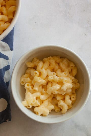 Two bowls of one pot gluten free mac and cheese on a napkin.