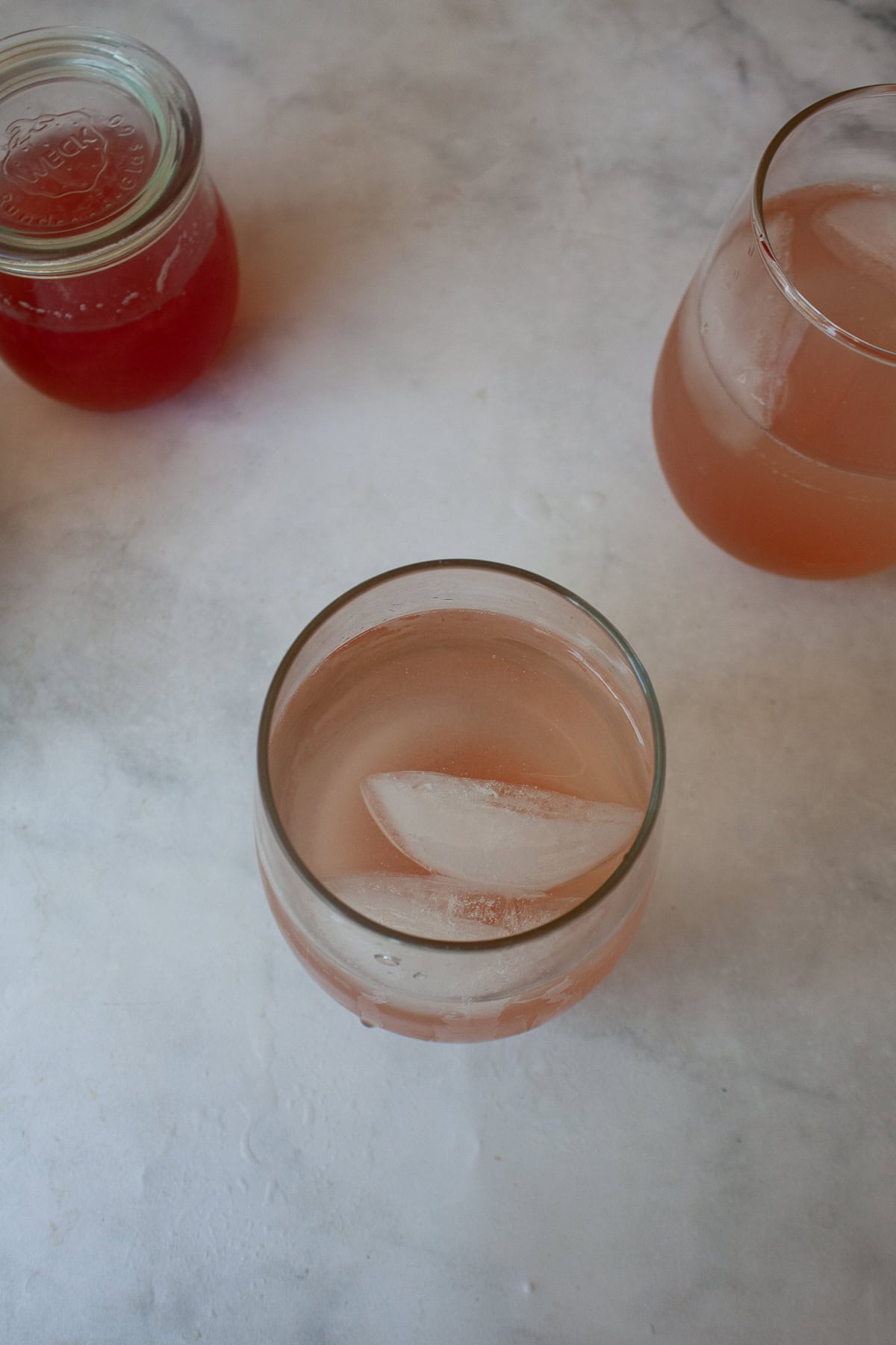 For a gorgeous twist on a classic, stir homemade rhubarb syrup into good gin and bubbly tonic water for a refreshing cocktail. A rhubarb gin and tonic with ice.