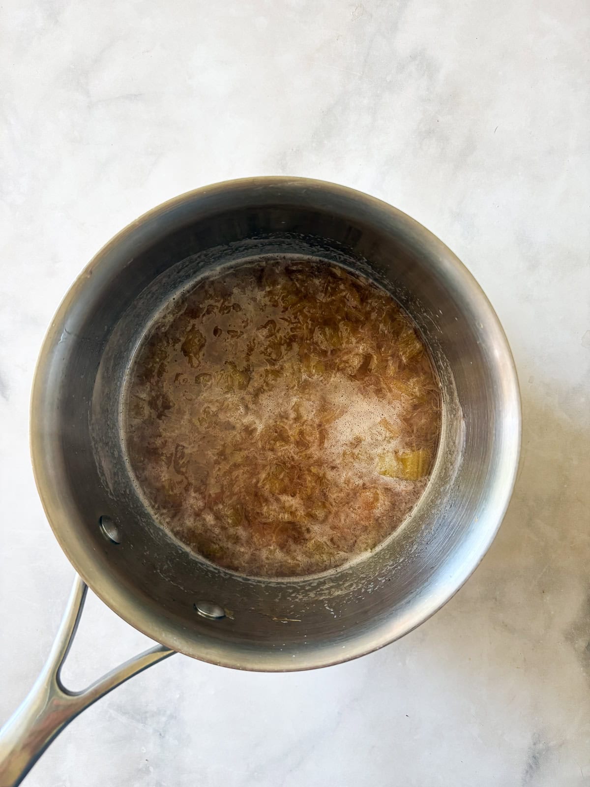 Gorgeously hued and perfectly sweet-tart, rhubarb simple syrup is a delightful addition to all sorts of drinks (and more). Rhubarb simple syrup cooks in a pot.