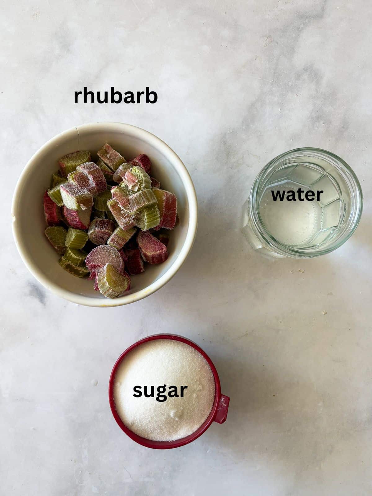 Gorgeously hued and perfectly sweet-tart, rhubarb simple syrup is a delightful addition to all sorts of drinks (and more). Ingredients for rhubarb simple syrup are text-labeled.