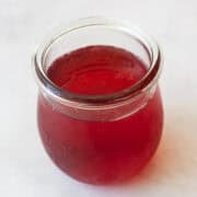 A little jar of strawberry simple syrup.