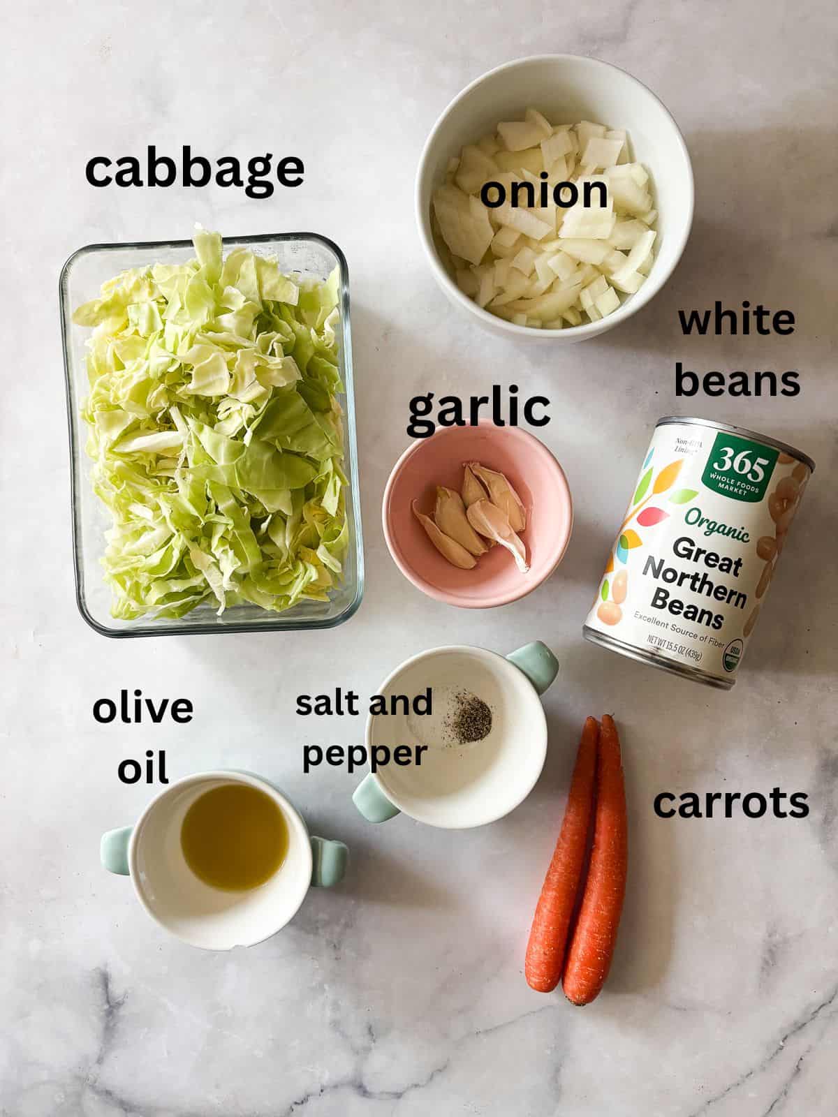 Quick, nourishing, and packed with savory veggies, tender cabbage, and hearty beans, this cabbage stir fry is super satisfying. Vegetarian! Ingredients for white bean and cabbage stir fry are text-labeled.