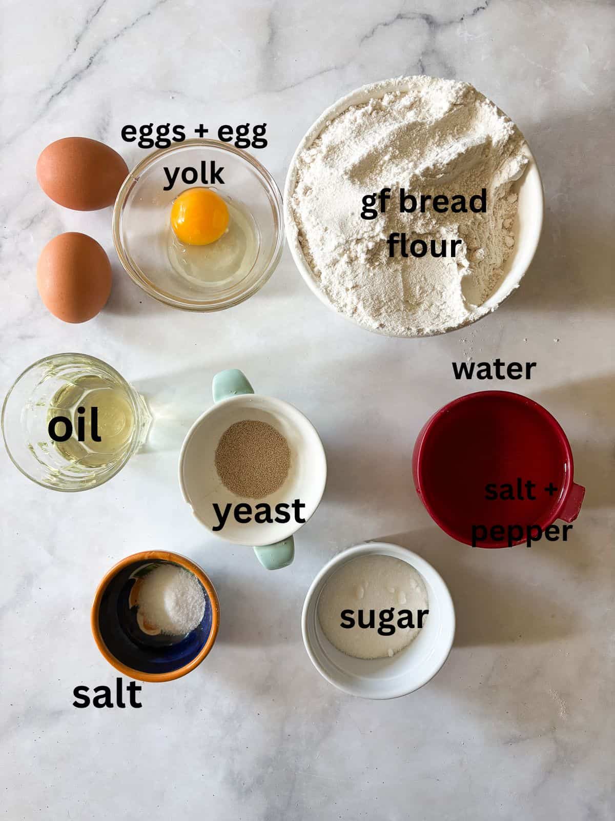 A gum-free recipe for a beautifully soft loaf of gluten free challah that's easy enough even for novice gluten-free bread bakers. Ingredients for gluten free challah are text-labeled.