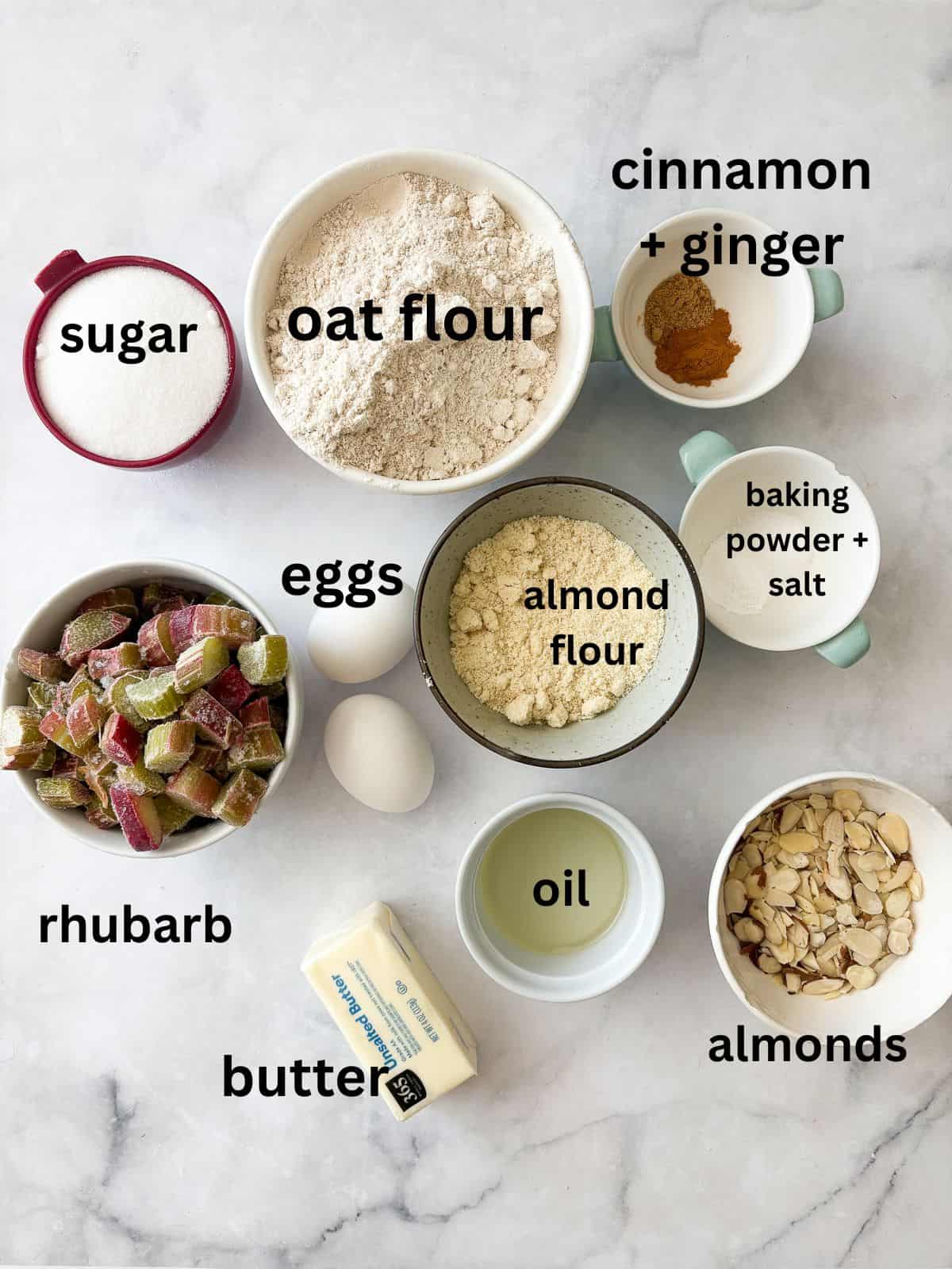 Tart rhubarb is the star of this gluten free rhubarb cake, with jammy pockets of rhubarb and a soft-crumbed cake that's just sweet enough. Ingredients for gluten free rhubarb cake are text-labeled.