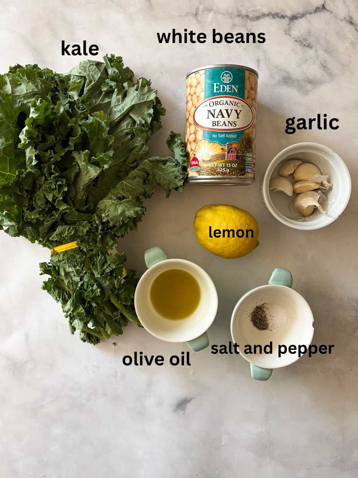 Garlicky white beans and kale are brightened up with lemon juice for a simple, satisfying, and QUICK vegetarian main. Ingredients for kale and white beans are text-labeled.