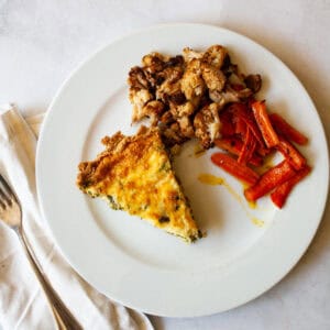 A plate of gluten free asparagus quiche and veggies.