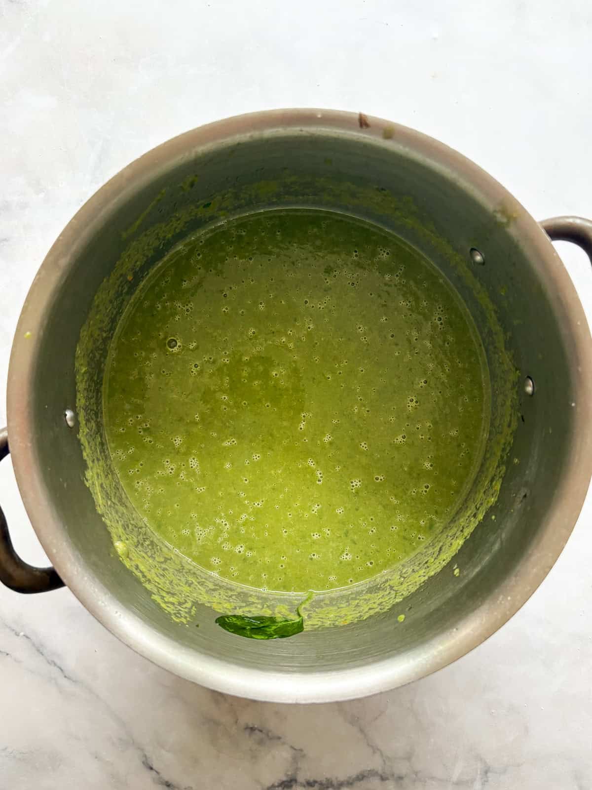 Creamy, vegan asparagus and spinach soup is made with minimal ingredients to create a velvety, nourishing soup that's always welcome. Asparagus and spinach soup pureed in a pot.