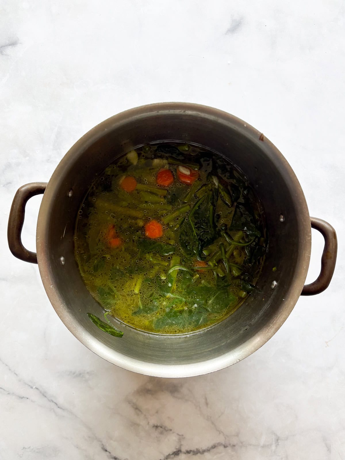 Creamy, vegan asparagus and spinach soup is made with minimal ingredients to create a velvety, nourishing soup that's always welcome. The vegetables are all cooked down.