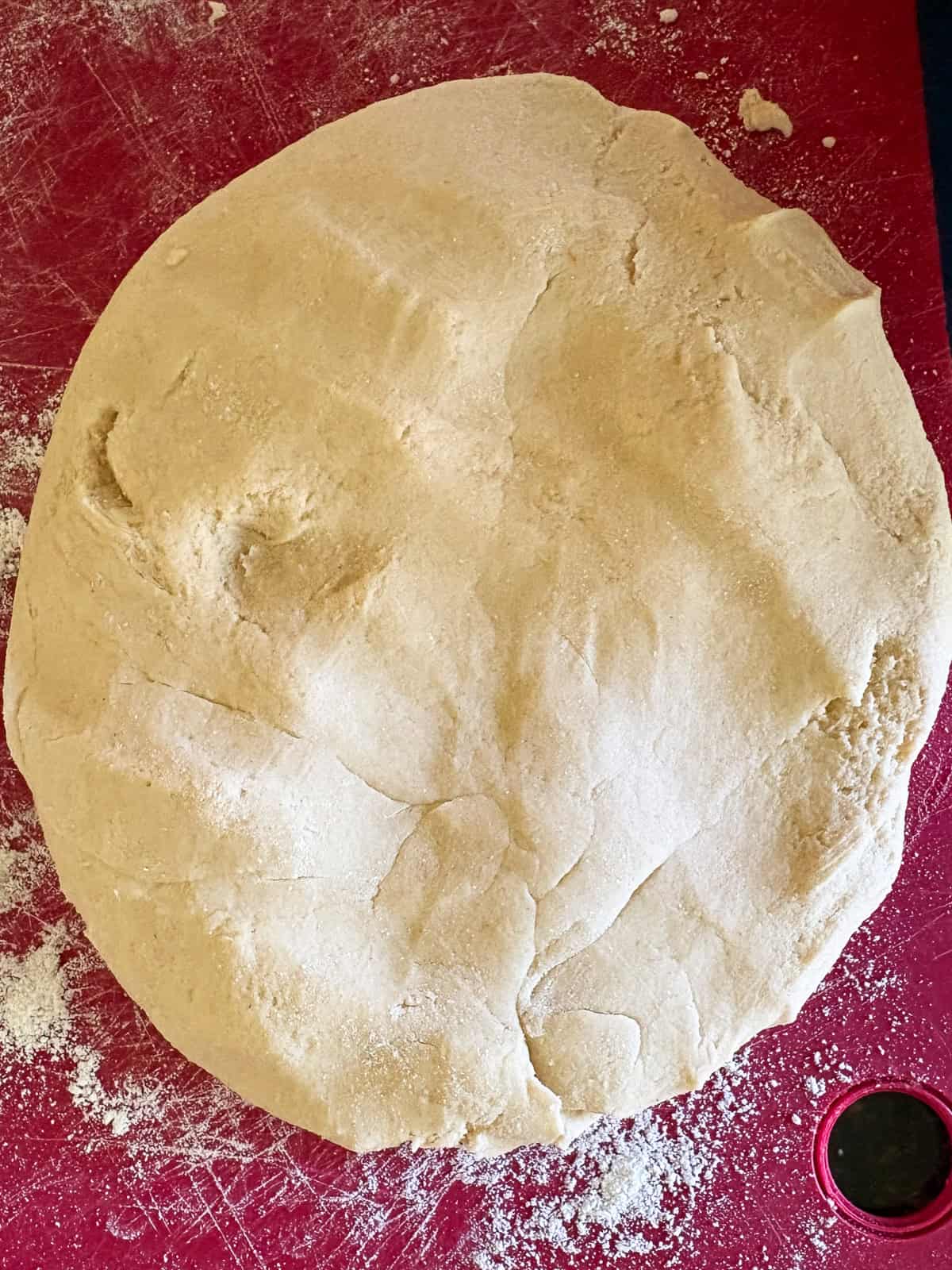 A gum-free recipe for a beautifully soft loaf of gluten free challah that's easy enough even for novice gluten-free bread bakers. A round of gluten free challah dough.