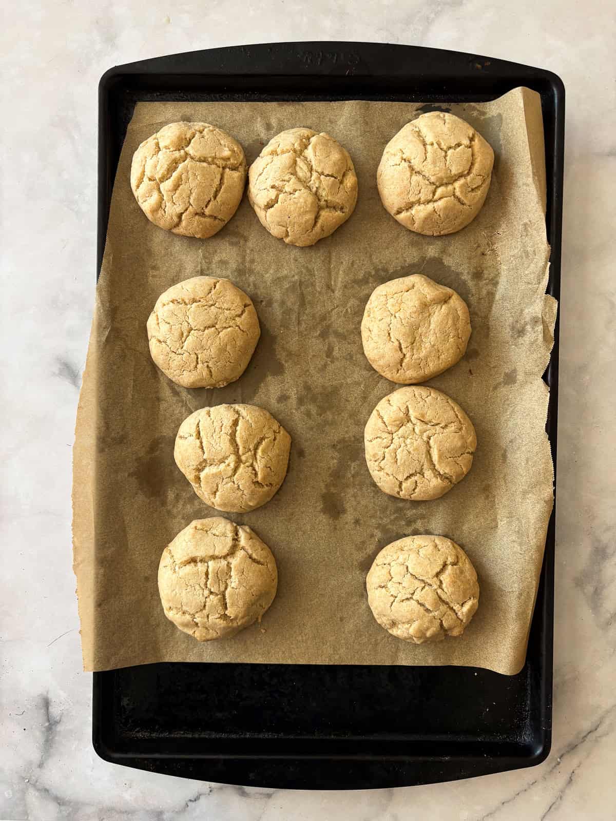 Tender and just lightly sweet gluten free cream biscuits are made in just one bowl with a handful of simple ingredients! Gluten free cream biscuits on a baking sheet after being baked.
