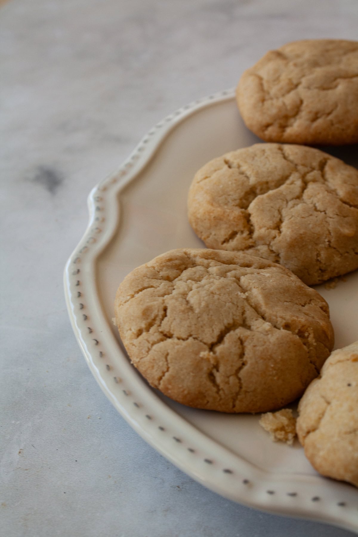 Tender and just lightly sweet gluten free cream biscuits are made in just one bowl with a handful of simple ingredients! A plate of gluten free cream biscuits.