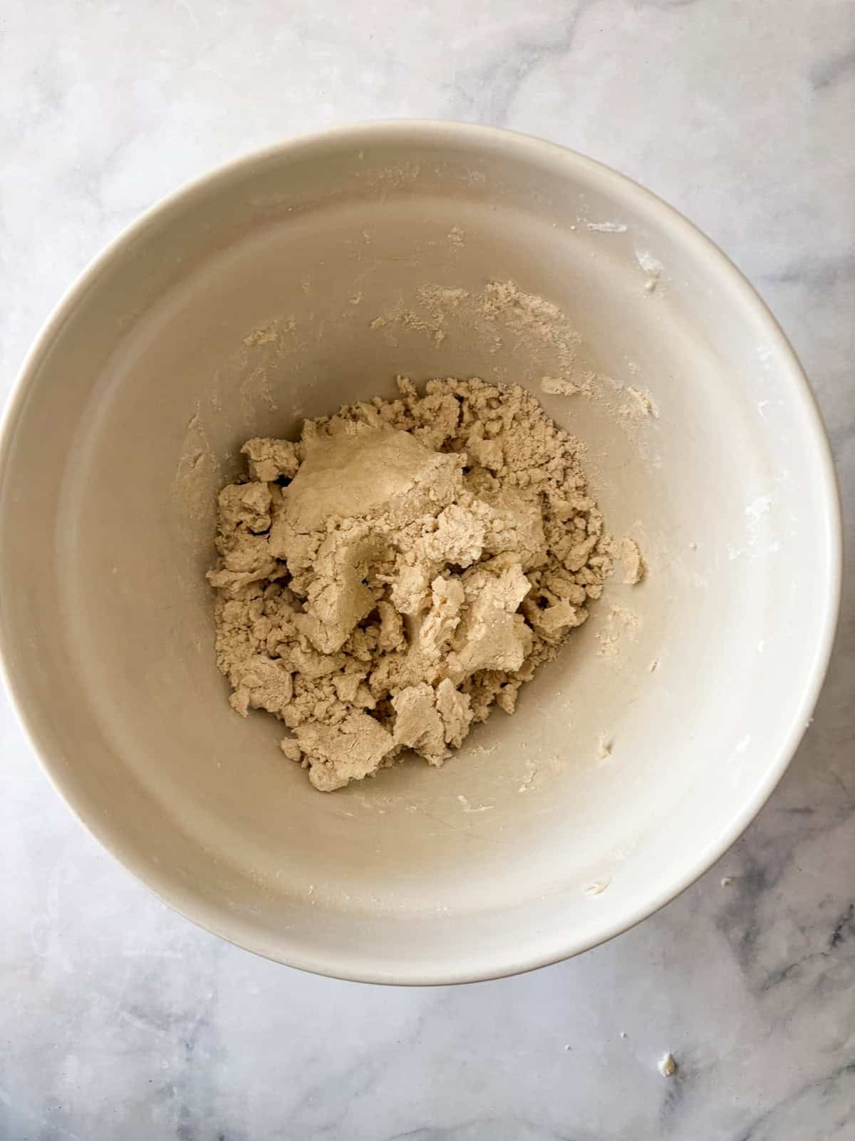 Tender and just lightly sweet gluten free cream biscuits are made in just one bowl with a handful of simple ingredients! Dough for gluten free cream biscuits in a bowl.