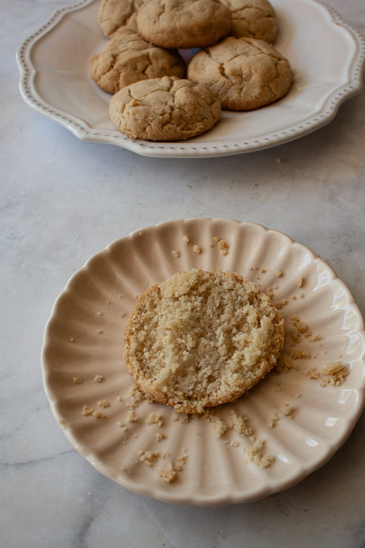 Tender and just lightly sweet gluten free cream biscuits are made in just one bowl with a handful of simple ingredients! A gluten free cream biscuit half on a plate.