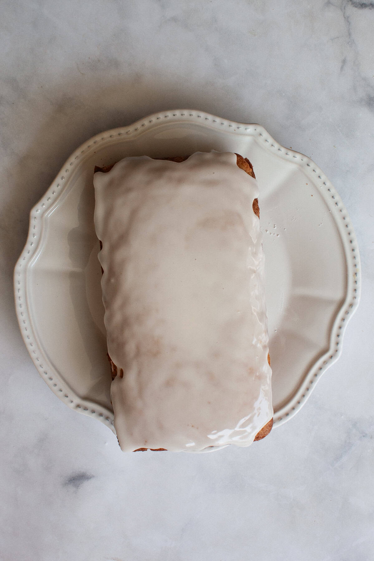A tender and moist yogurt-based crumb makes this pretty gluten free olive oil grapefruit cake stand out. Finished with grapefruit glaze! Glaze is added to a loaf of gluten free grapefruit bread.