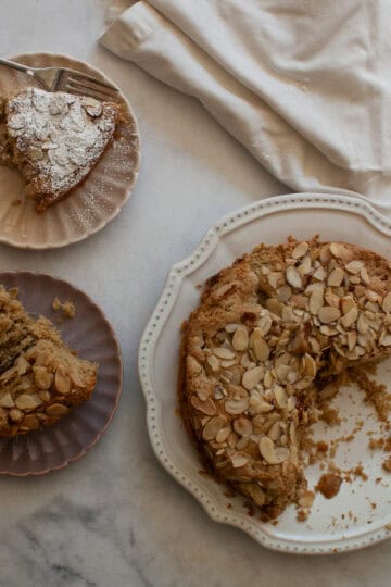 Slices of gluten free rhubarb cake on plate next to the cake.