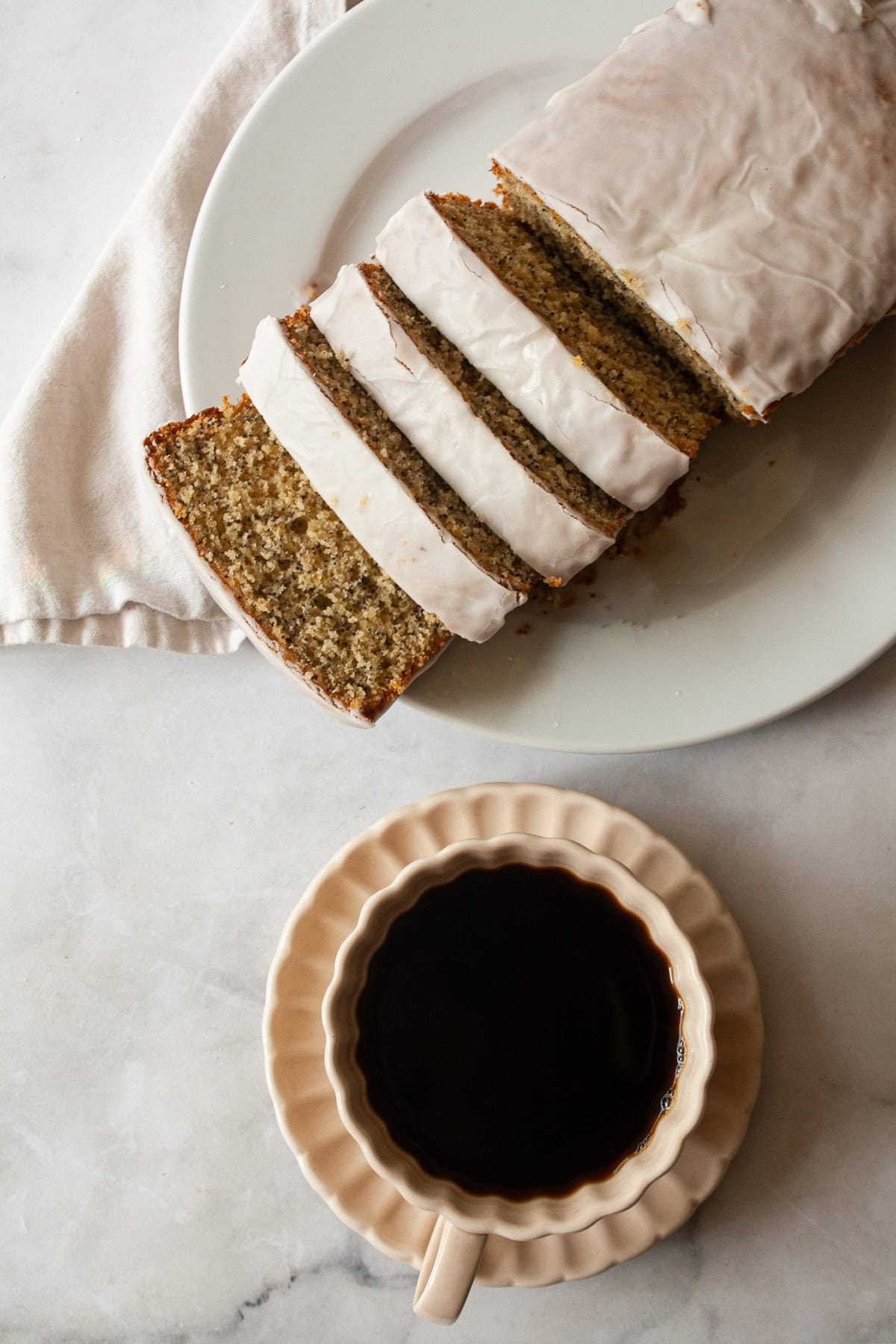 A gluten free orange loaf cake topped with orange glaze.